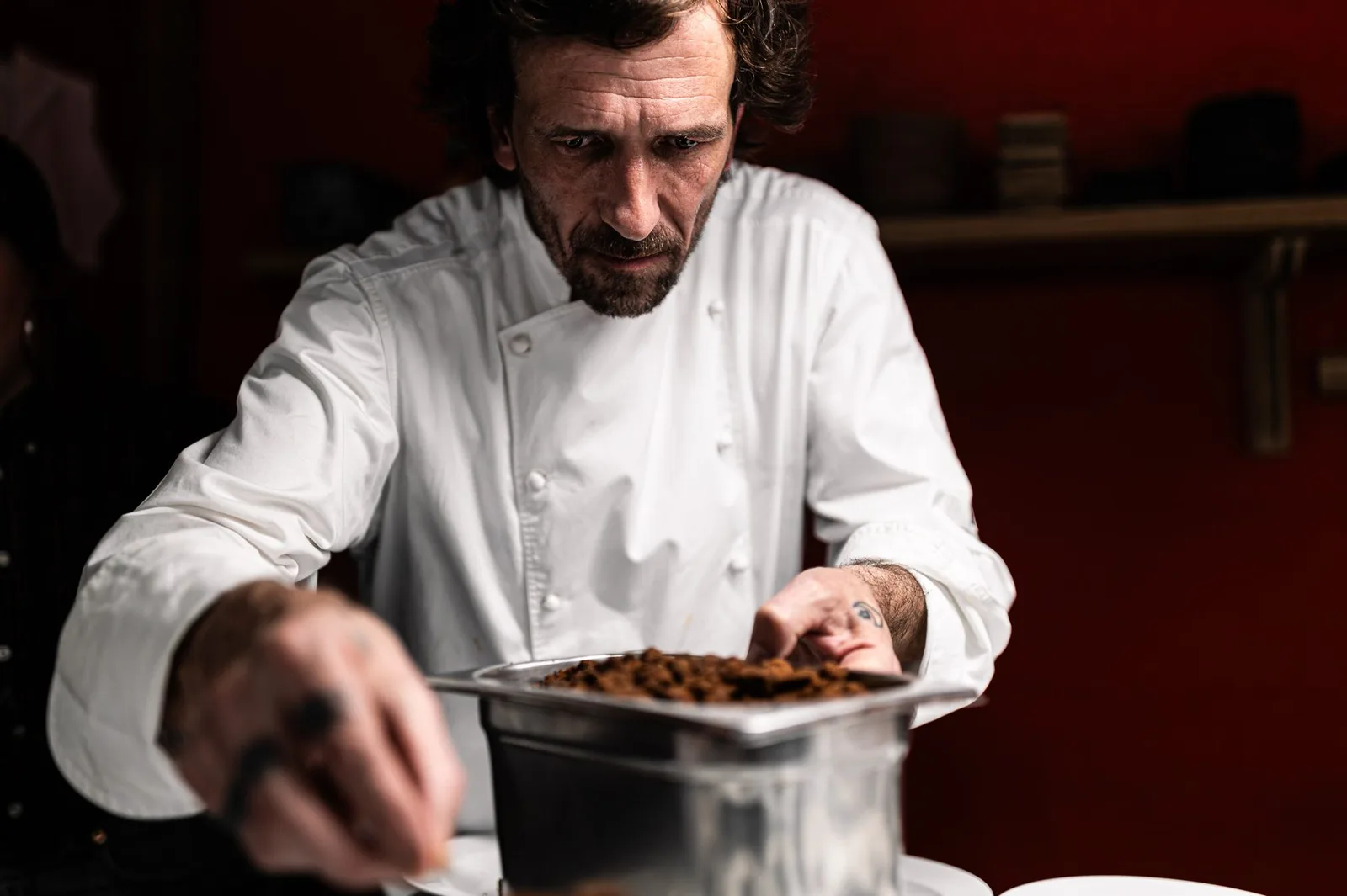 Chef plating a dish in the kitchen