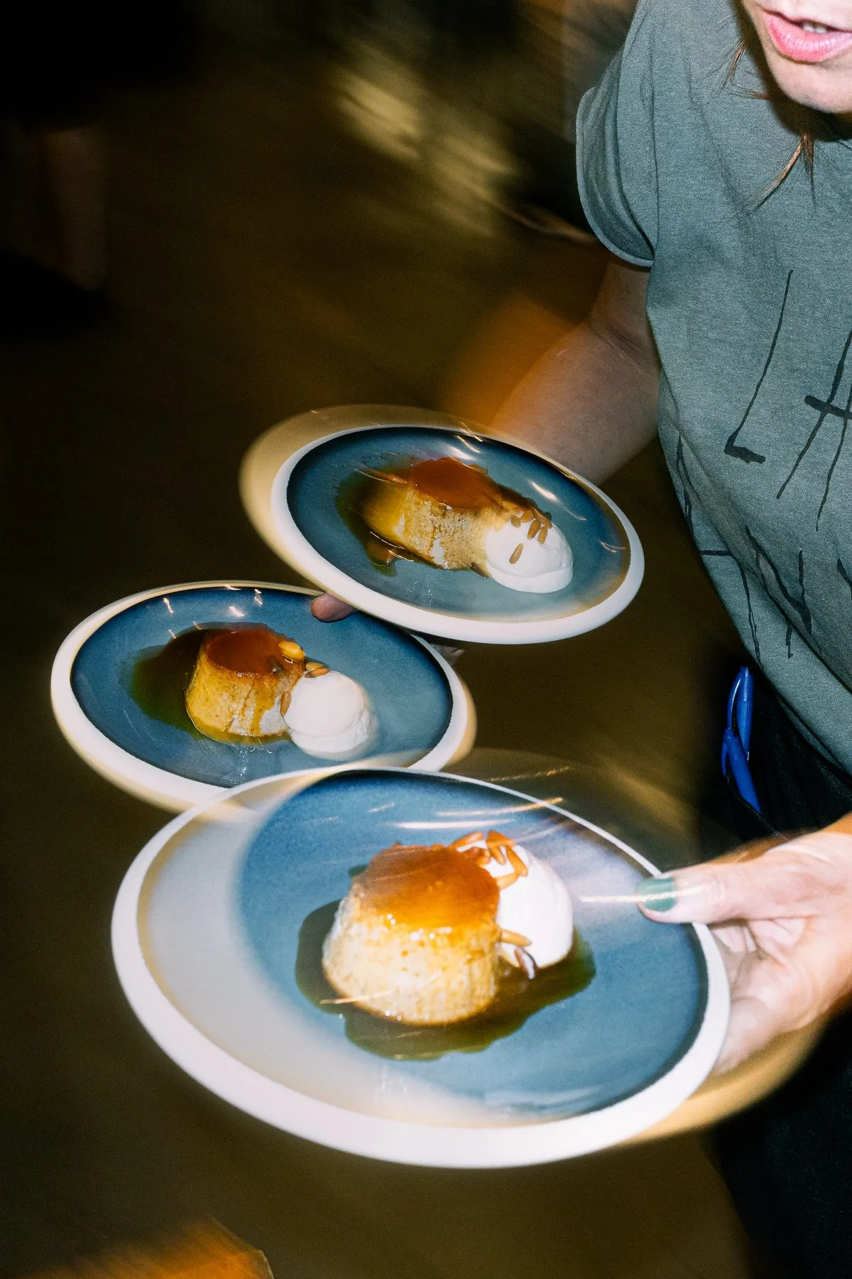 Waiter serving a plated dessert in a restaurant